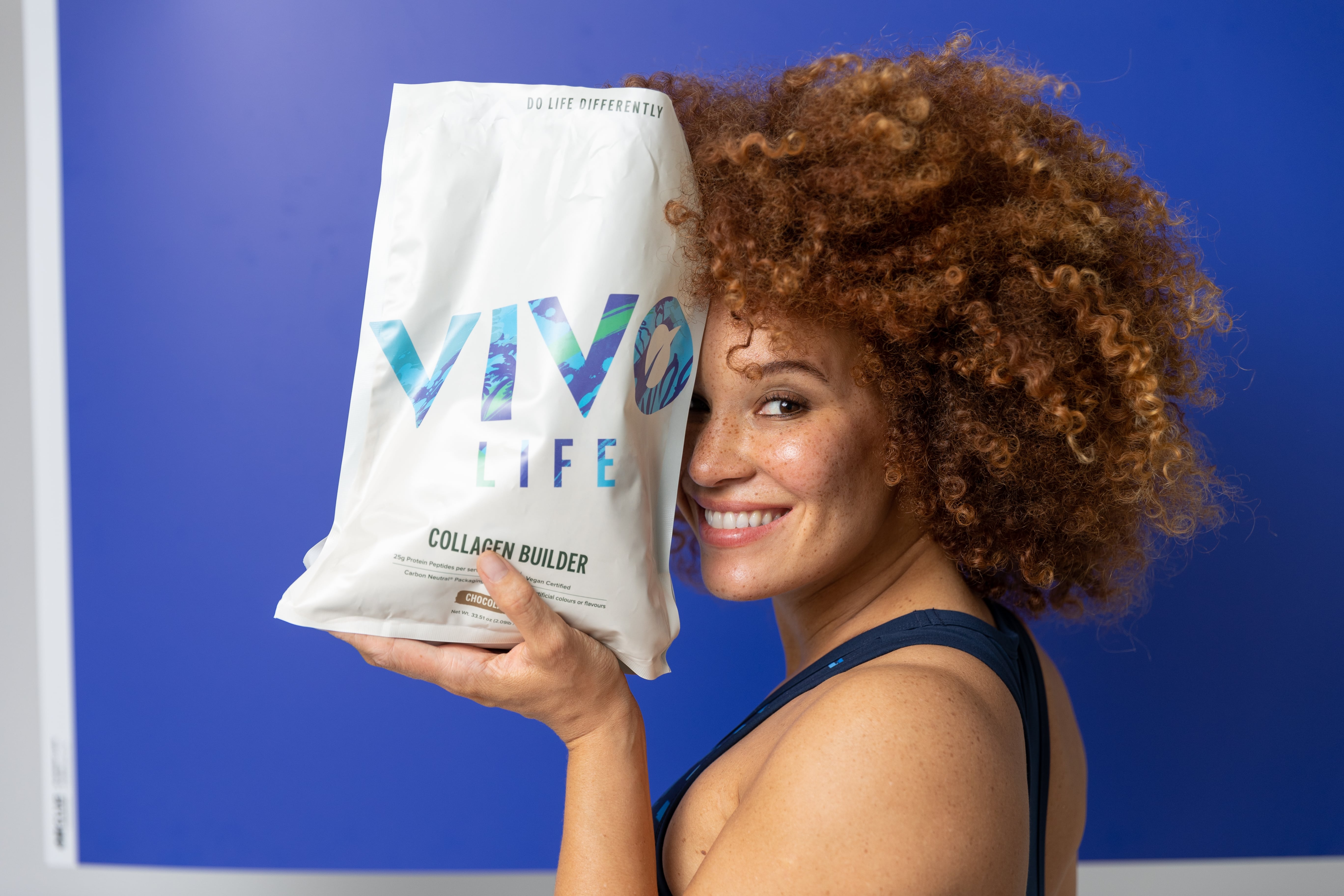 Futureproof October 23 Yasmin holding Choc Collagen blue background 6-min